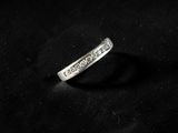 an image of a diamond ring sitting on top of a black cloth