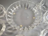 a lot of glass dishes and cups on the table