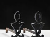 pair of metal sculptures of a man and a woman on a wooden stand