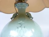 a lamp that is sitting on a table with a lamp shade on it