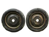 pair of old wheels on a white background with a hole in the center