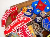 a wooden tray with a bunch of badges on it