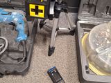 a tool set up on the floor next to a tool case