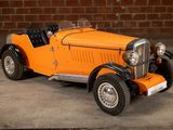 an orange car parked in front of a brick wall