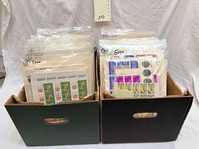 two boxes with stamps and envelopes in them on a table