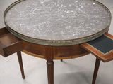 a marble top table with a drawer underneath it