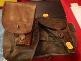 a brown bag sitting on top of a table next to a laptop