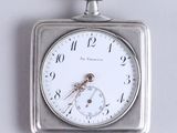 a silver pocket watch with a white face on a chain