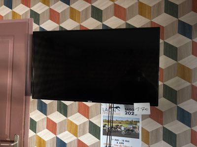 a flat screen tv hanging on a wall in a room