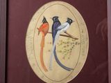 two birds that are sitting on a branch in the picture