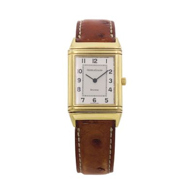 a gold plated rectangular watch with brown leather strap