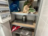 a small pantry with a lot of items on the shelves