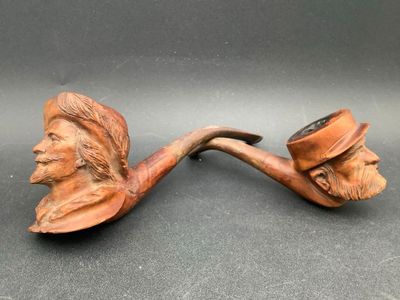 a close up of a pipe with a man ' s face on it