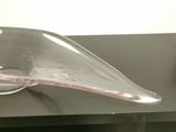 a glass sculpture of a bird sitting on a table