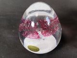 a snow globe with a snowman inside of it on a table
