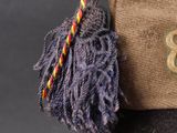 a brown bag with a rope and a button on it