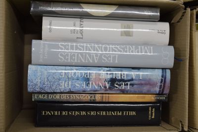 plusieurs livres empilés dans une boîte