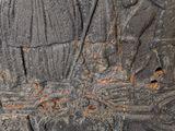 a stone carving of a man and a woman on a boat