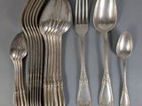 a lot of silver spoons and spoons on the table