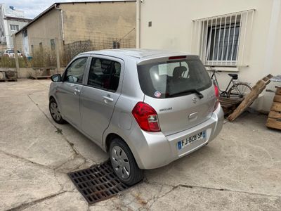 a small silver car parked in front of a building