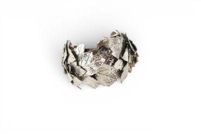 an image of a close up of a silver ring on a white surface
