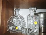 two bottles of liquor on a shelf in a cabinet
