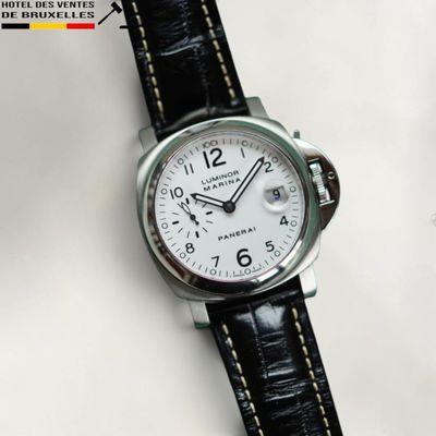 a close up of a watch on a white surface