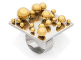 a close up of a ring with gold spheres on it