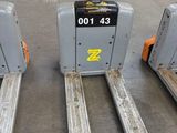 three forklifts that are sitting in a warehouse