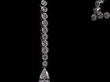 two pieces of jewelry are shown against a black background