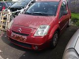 a red car parked in a parking lot next to other cars