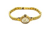 an image of a woman ' s wrist watch on a gold bracelet