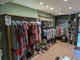 a lot of clothes hanging on a rack in a store