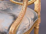 an antique chair with a blue and gold upholstered upholstered seat