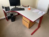 a desk with a computer monitor and a keyboard on it
