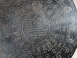 a silver plate with writing on it on a table