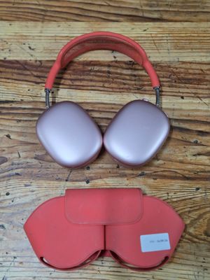 pair of pink and silver headphones on a wooden table