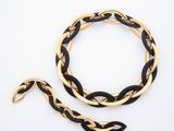 a close up of a black and gold bracelet and a gold chain