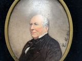 an old picture of a man in a black suit and bow tie