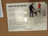 a sign for a table hockey game in a store