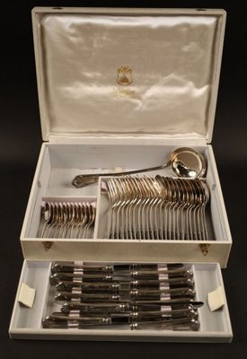 a box with silverware in it on a black surface