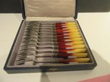 a box of silverware with a variety of spoons in it