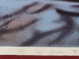 a picture of a person laying in bed with their hand on the pillow