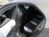 a white car with black seats and a door open