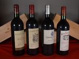 several bottles of wine are lined up on a red cloth