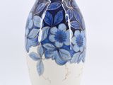 a blue and white vase with blue flowers on it
