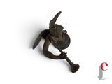 an old iron hook with a bird on it