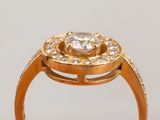 a gold ring with a diamond center surrounded by smaller diamonds