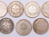 six different types of silver coins on a white surface