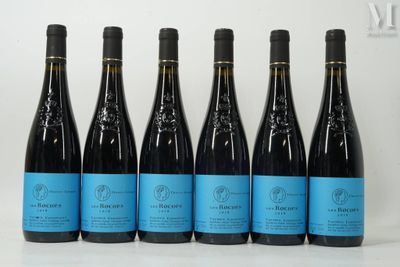 six bottles of wine lined up in a row on a table